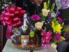 This large basket boasts a wide variety of local and imported fruits: grapes, apples, pears, kiwi, plum, pineapple, banana and more and has a bottle of sparkling non alcoholic wine as well a medium mixed arrangement of roses, lilies carnations and a balloon for the occasion. Delight all sense with fragrant Bath and Body works lotion and shower gel.