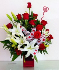 Mixed Arrangement of roses and lilies or cut Orchid blooms in lovely colors for the season